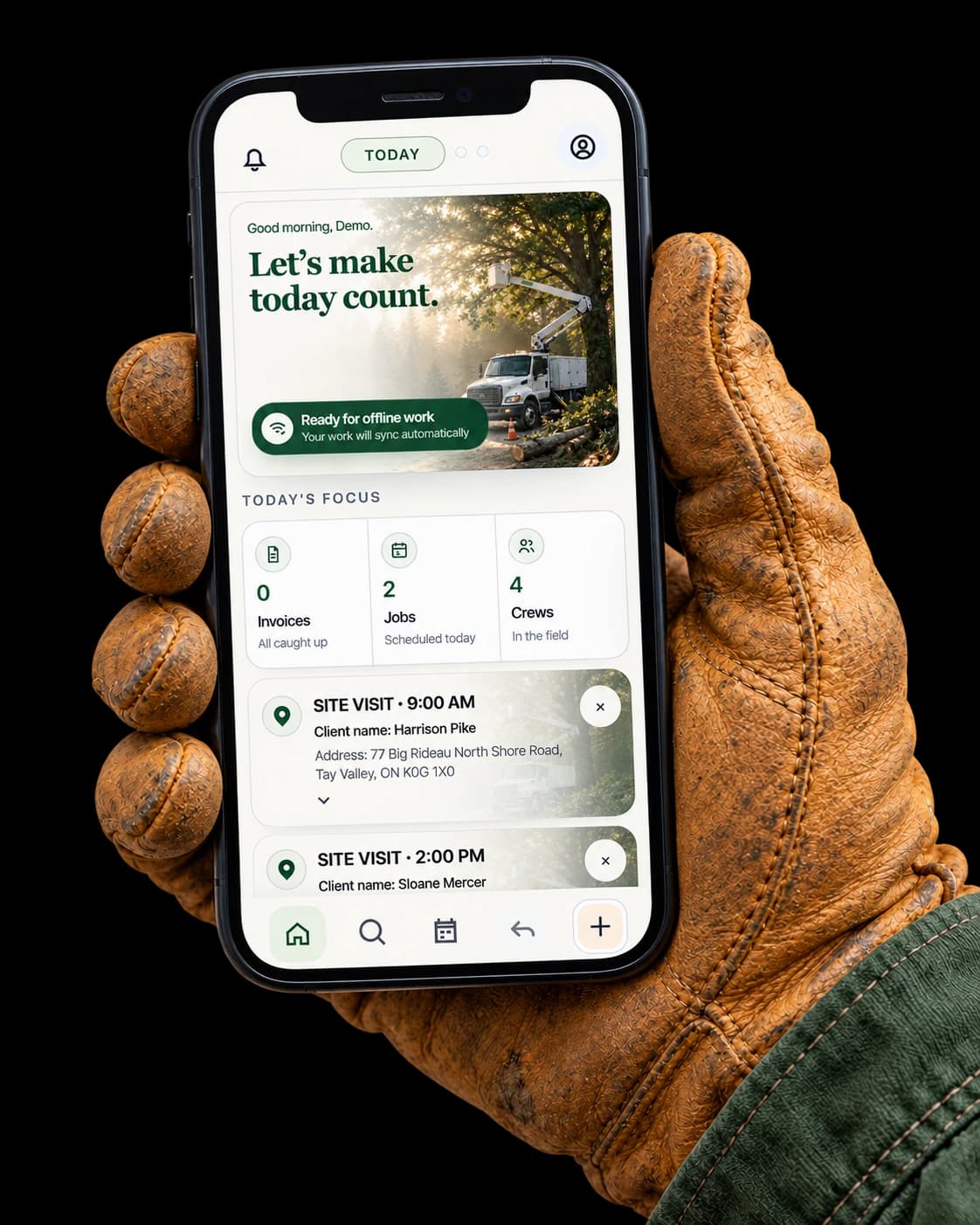 A work-gloved hand holding a phone displaying True Arbor’s Today screen, daily priorities, and scheduled site visits.
